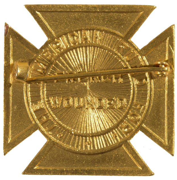 Gold American Fire Department badge with a central star and inscribed text.