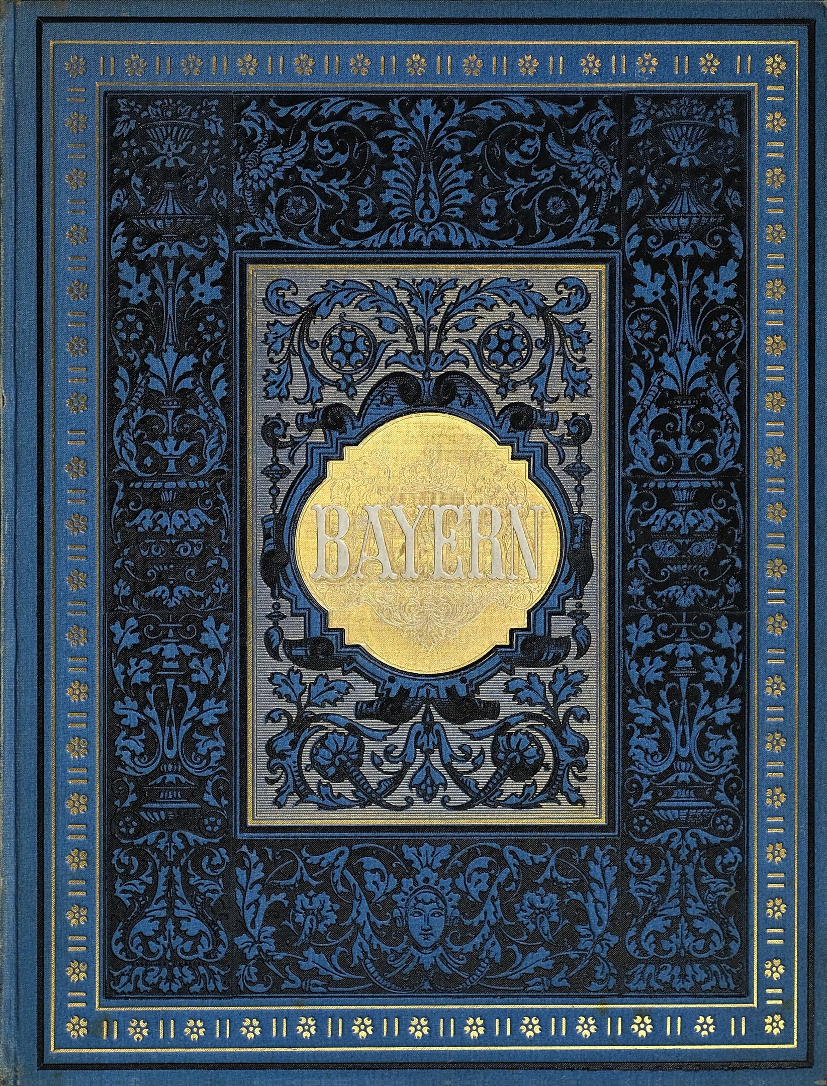 Ein blau-goldenes Buch mit der Aufschrift "Bayern" auf dem Cover, verziert mit detaillierten Designs.